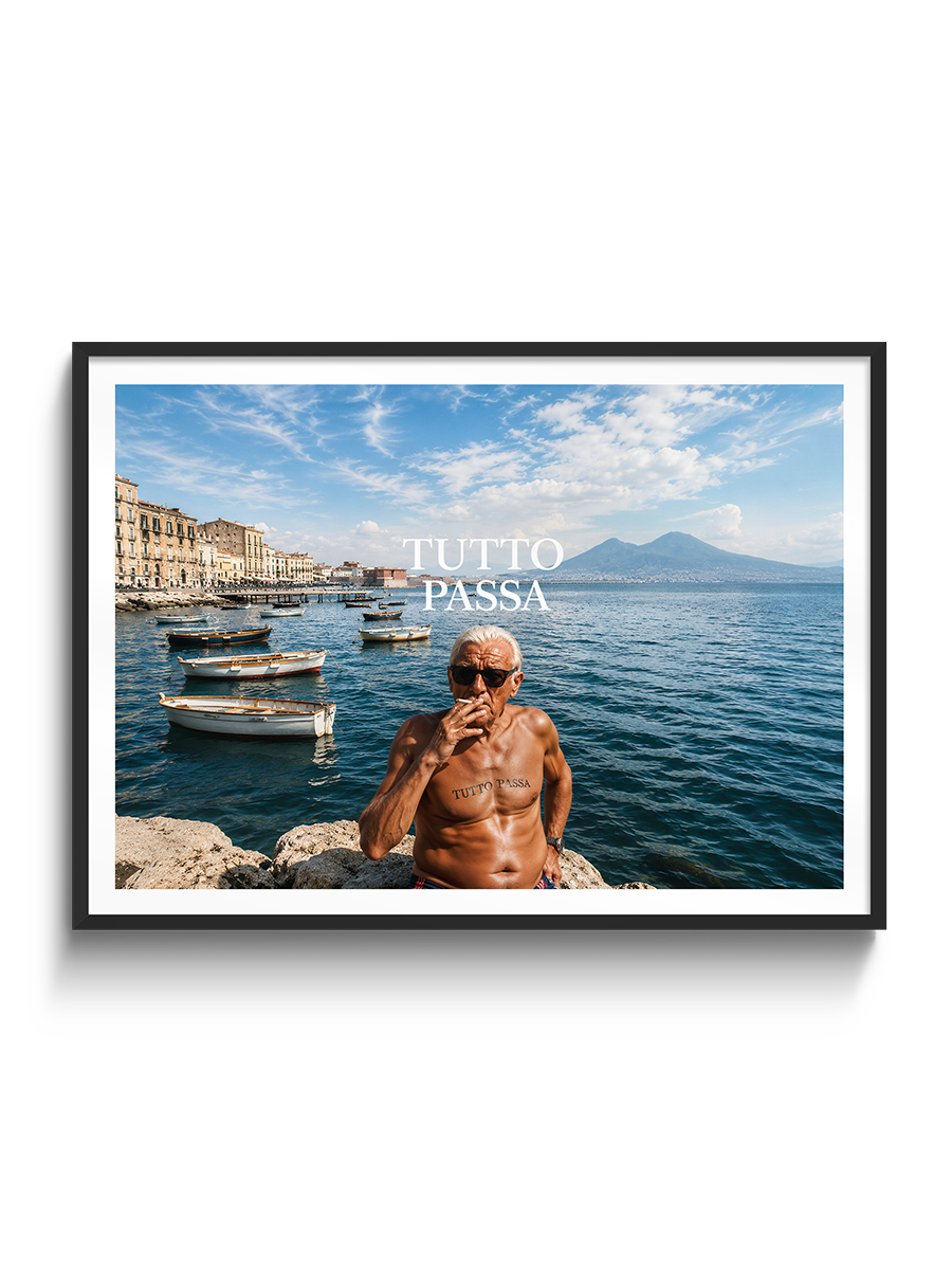 A framed photographic print featuring a shirtless man smoking on a rocky waterfront with boats and a blue sky, with the text 'TUTTO PASSA' overlaid. The print is shown in a black frame with a white mat against a light gray background.