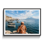 A framed photographic print featuring a shirtless man smoking on a rocky waterfront with boats and a blue sky, with the text 'TUTTO PASSA' overlaid. The print is shown in a black frame with a white mat against a light gray background.