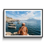 A framed photographic print featuring a shirtless man smoking on a rocky waterfront with boats and a blue sky, with the text 'TUTTO PASSA' overlaid. The print is shown in a black frame with a white mat against a light gray background.